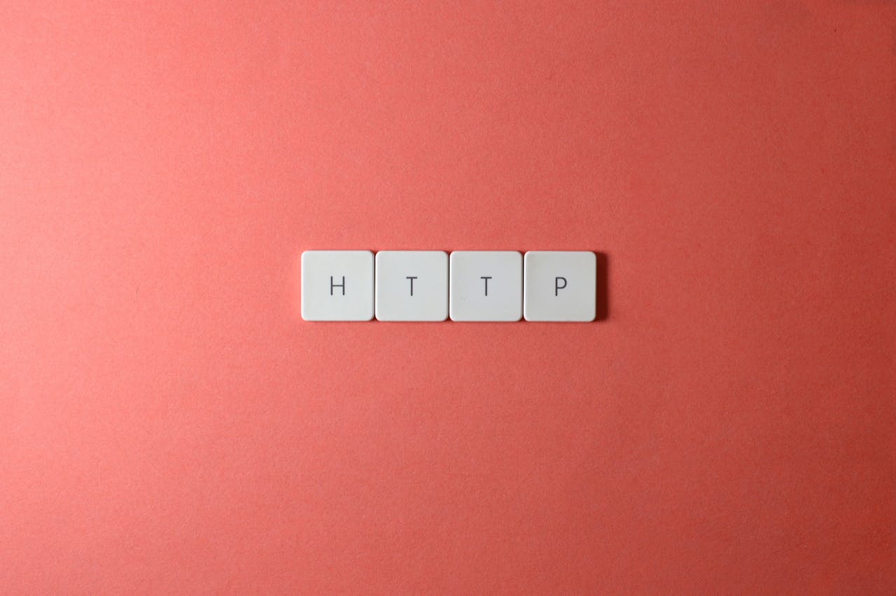 HTTP spelled with keyboard keys on a pink background, minimalist style.